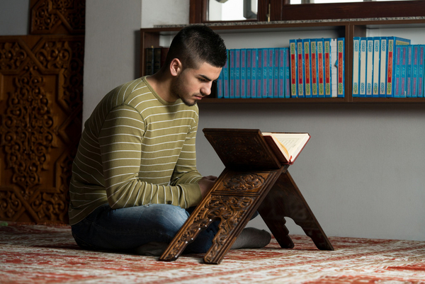 Young Muslim Guy Reading The Koran Koran Ramadan COLOURBOX9397002